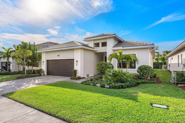 view of front of property featuring a front yard and a garage