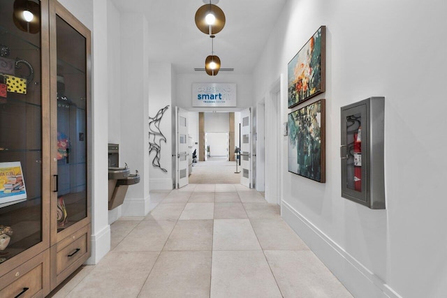 hall with light tile patterned floors