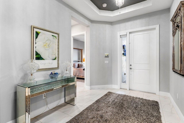 entrance foyer featuring a tray ceiling