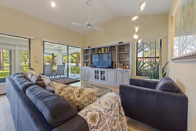 living room with light wood-type flooring, ceiling fan, and lofted ceiling