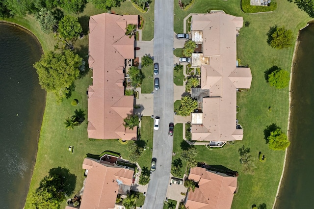 drone / aerial view featuring a water view and a residential view