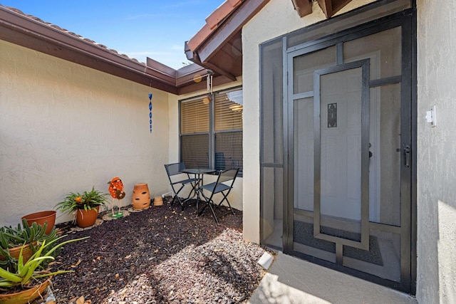 entrance to property with stucco siding