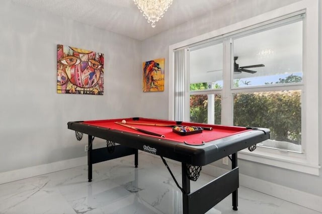 recreation room with ceiling fan with notable chandelier, a healthy amount of sunlight, and billiards