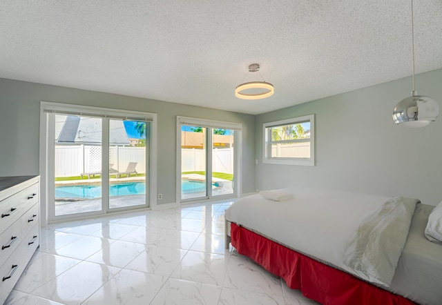 bedroom with a textured ceiling and access to outside