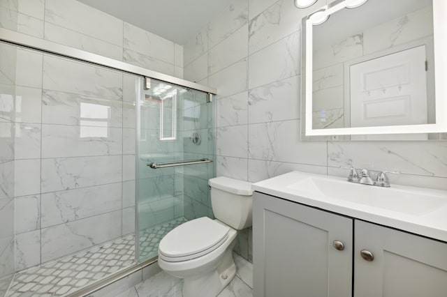 bathroom featuring vanity, toilet, tile walls, and a shower with shower door