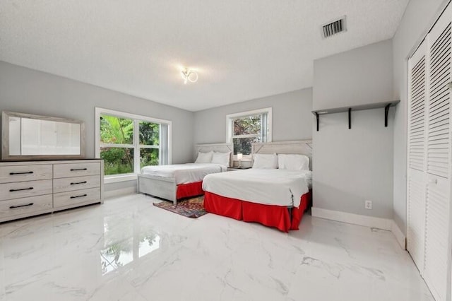 bedroom with a closet and a textured ceiling