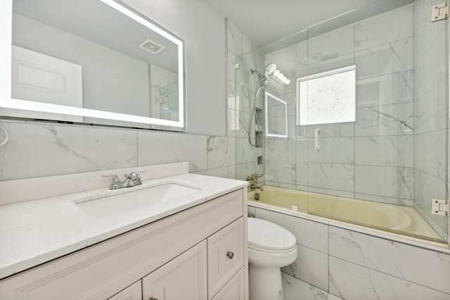 full bathroom with vanity, enclosed tub / shower combo, and toilet