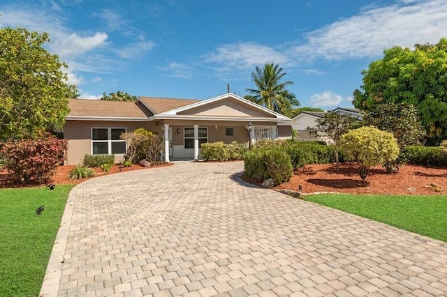 ranch-style home with a front lawn