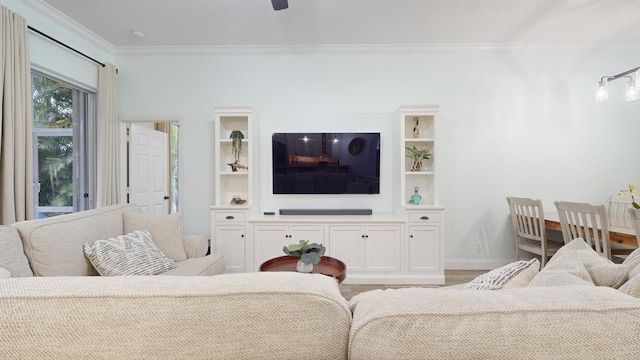 living room with light hardwood / wood-style flooring, ceiling fan, and crown molding