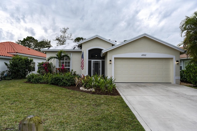 ranch-style home featuring a garage and a front yard