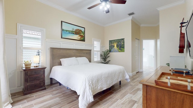 bedroom with a closet, ceiling fan, and ornamental molding