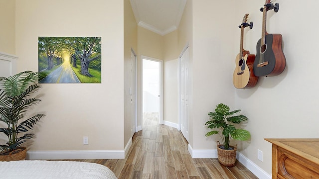 corridor featuring light hardwood / wood-style floors and crown molding