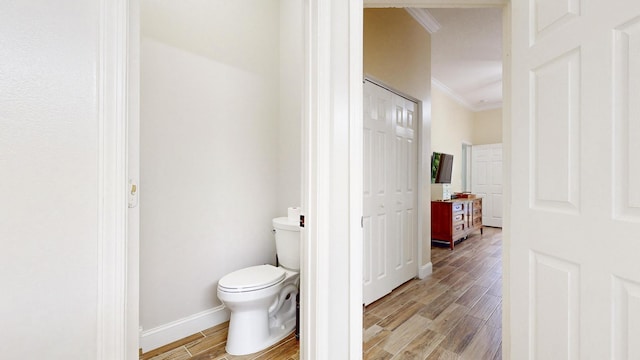 bathroom with toilet and crown molding