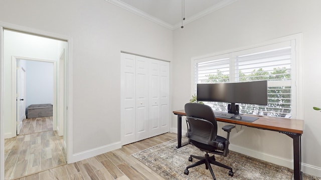 office area with light hardwood / wood-style floors, ornamental molding, and a towering ceiling