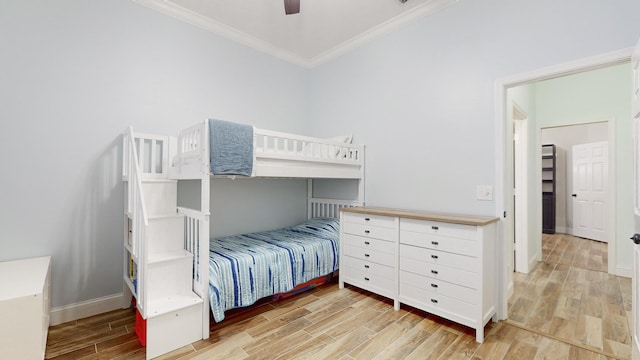 bedroom with ceiling fan and crown molding