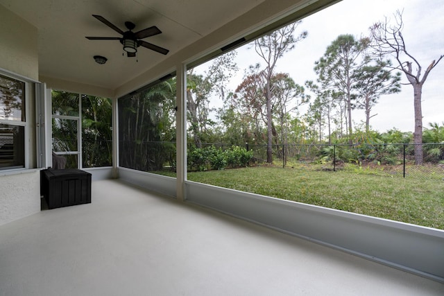 unfurnished sunroom with ceiling fan