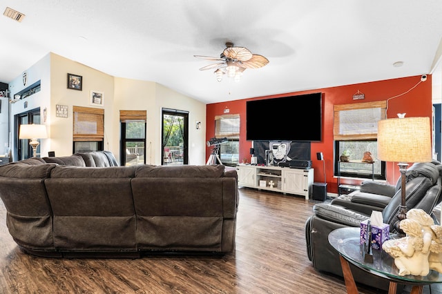 living room with vaulted ceiling, ceiling fan, and dark wood-type flooring