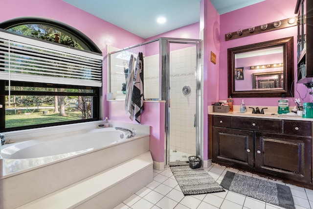 bathroom with tile patterned flooring, vanity, and shower with separate bathtub