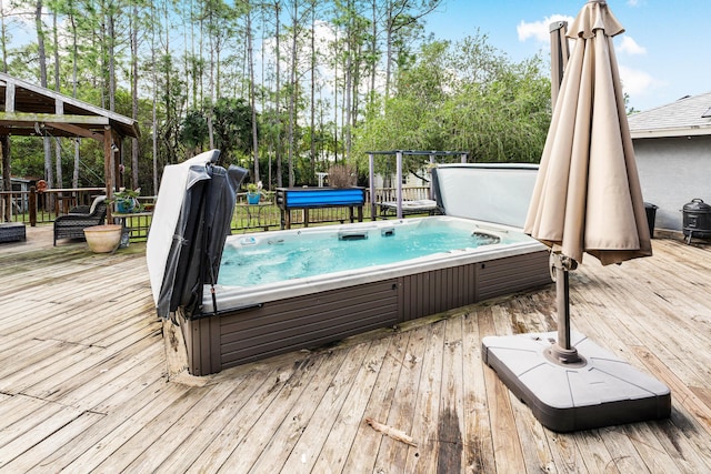 view of swimming pool with a wooden deck