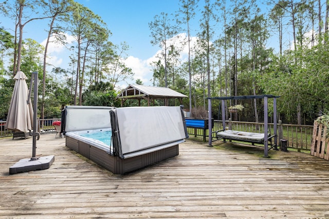 deck with a gazebo and a covered hot tub