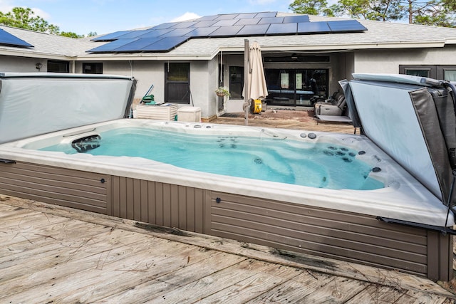 wooden deck featuring a covered hot tub