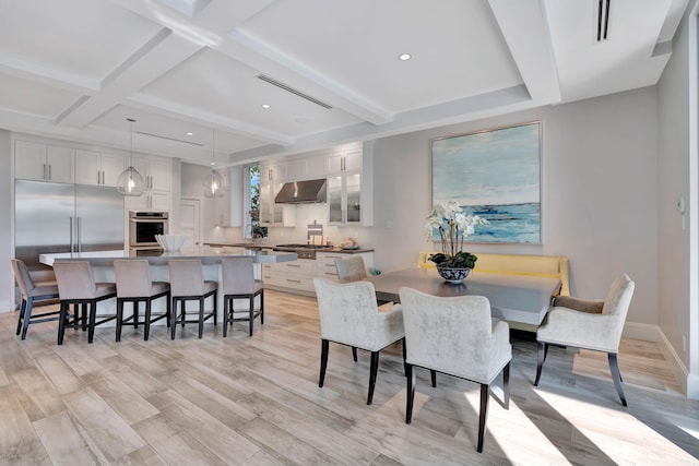 dining room with beam ceiling, light hardwood / wood-style flooring, coffered ceiling, and sink