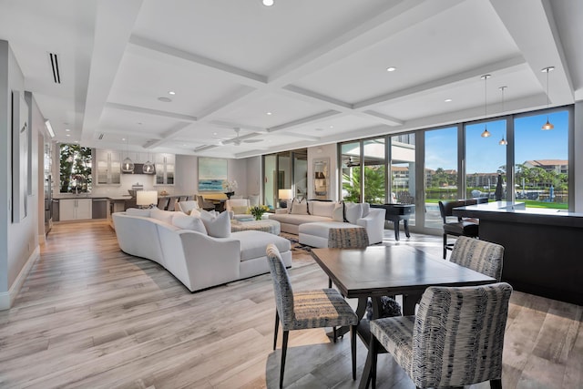 living room with floor to ceiling windows, coffered ceiling, ceiling fan, beam ceiling, and light hardwood / wood-style flooring