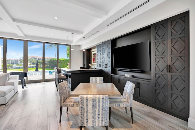 dining space featuring beamed ceiling and coffered ceiling