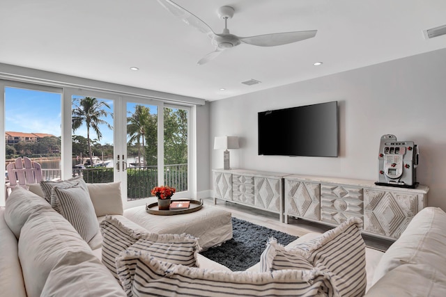 living room with ceiling fan, french doors, and hardwood / wood-style flooring