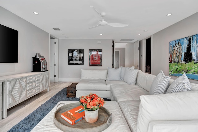 living room with light wood-type flooring and ceiling fan