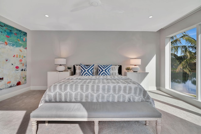 carpeted bedroom with multiple windows and ceiling fan