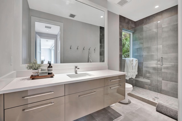 bathroom with vanity, toilet, and walk in shower