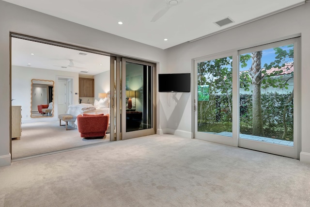 carpeted empty room featuring french doors, a wealth of natural light, and ceiling fan