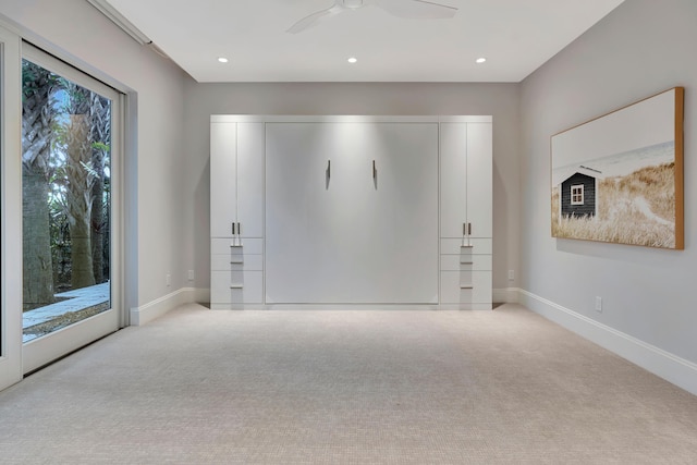 unfurnished bedroom featuring access to exterior, light colored carpet, and ceiling fan