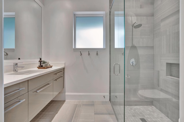 bathroom with tile patterned floors, vanity, and walk in shower