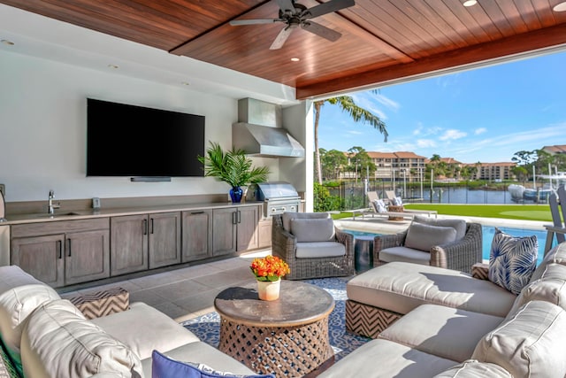 view of patio with area for grilling, ceiling fan, sink, and exterior kitchen