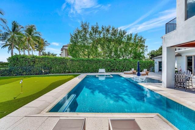 view of swimming pool with a patio area