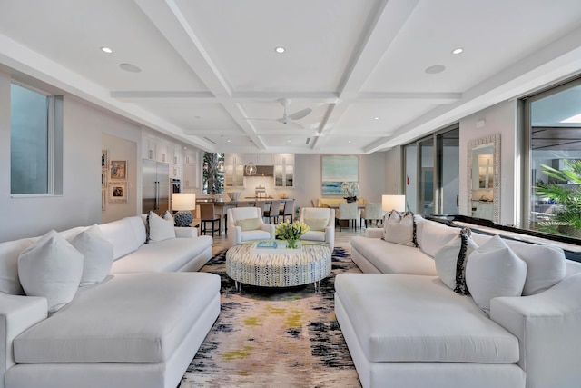 living room featuring beam ceiling, ceiling fan, and coffered ceiling