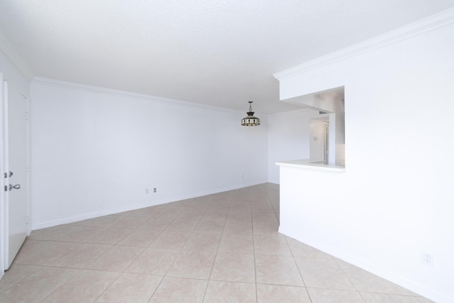 spare room with crown molding and light tile patterned floors