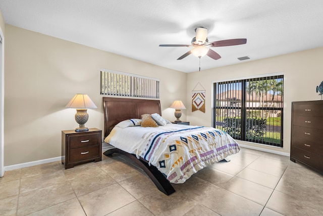 tiled bedroom featuring ceiling fan