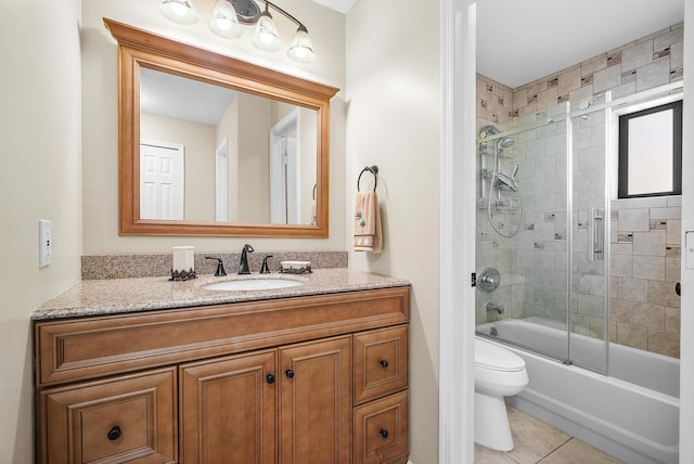 full bathroom with tile patterned floors, vanity, toilet, and enclosed tub / shower combo