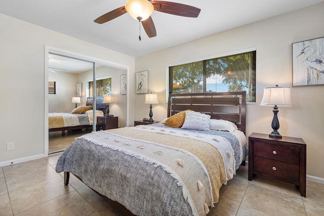 tiled bedroom with ceiling fan and a closet