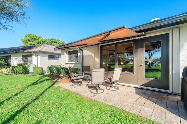 back of property featuring a yard and a patio