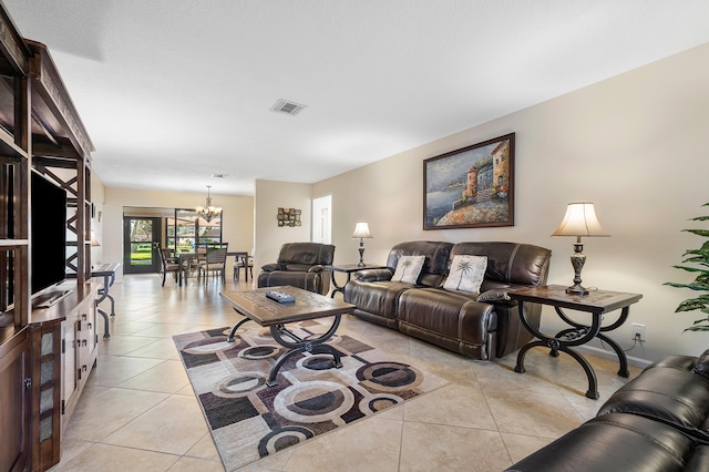 living room featuring light tile patterned floors and a chandelier