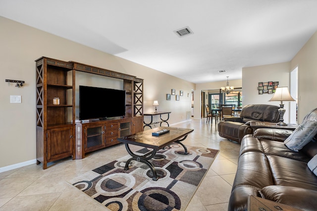 living room featuring a notable chandelier and light tile patterned floors