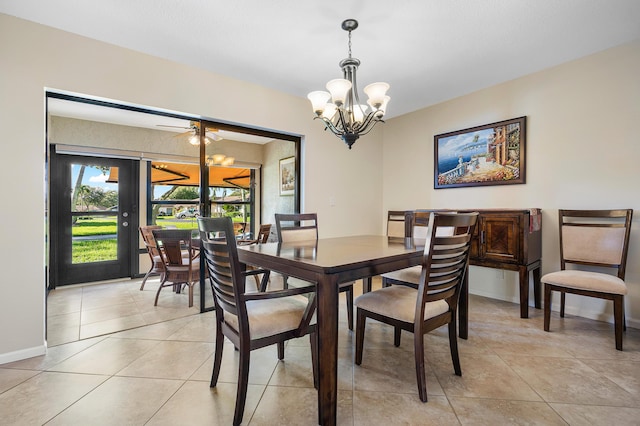 dining area with french doors, light tile patterned floors, and ceiling fan with notable chandelier