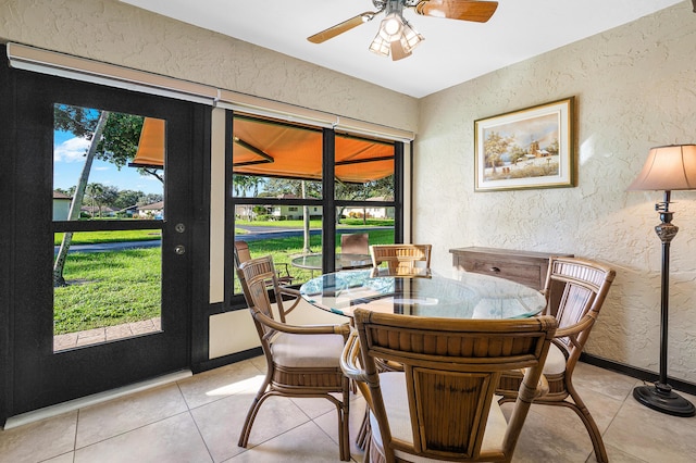 dining area featuring ceiling fan and light tile patterned flooring