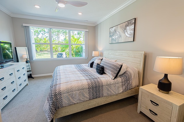 carpeted bedroom with ornamental molding and ceiling fan