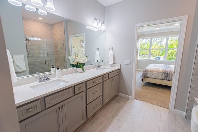 bathroom with a shower with door and vanity