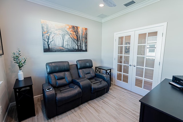 home theater featuring light hardwood / wood-style floors, french doors, and crown molding